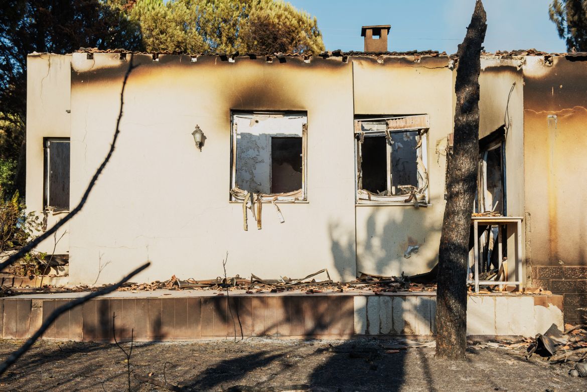 A burned house stands among debris following a wildfire in the Seferihisar district of Izmir, Turkey, on June 30, 2025