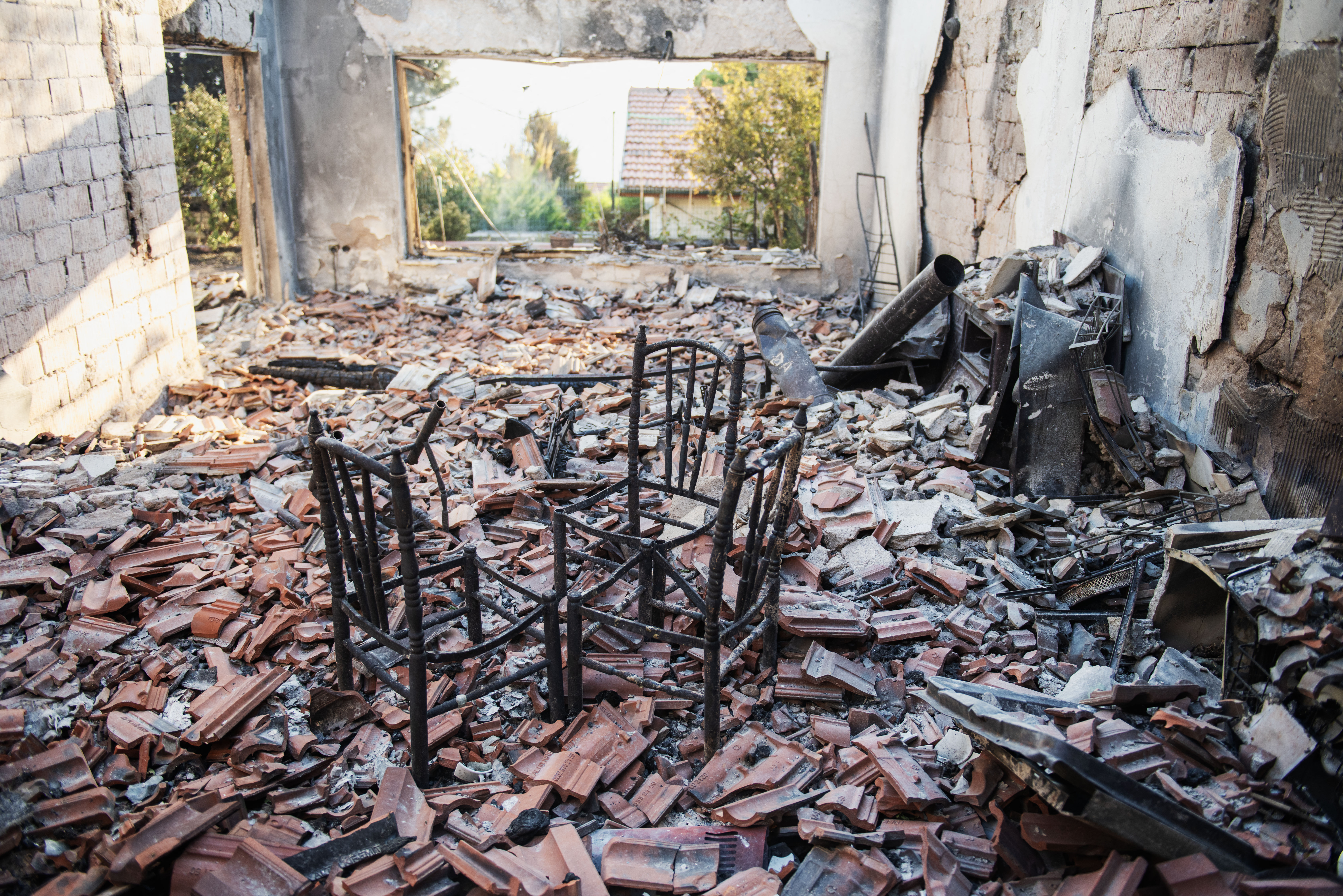 A burned house stands among debris following a wildfire in the Seferihisar district of Izmir, Turkey, on June 30, 2025