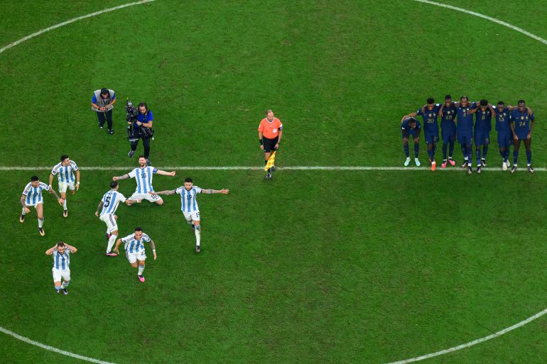 LUSAIL CITY, QATAR - DECEMBER 18: Lionel Messi of Argentina and his team mates celebrate the fourth and winning penalty by Gonzalo Montiel in the penalty shootout as France players react during the FIFA World Cup Qatar 2022 Final match between Argentina and France at Lusail Stadium on December 18, 2022 in Lusail City, Qatar. (Photo by Matthias Hangst/Getty Images)